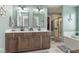 Elegant main bathroom features double vanity, soaking tub, and a separate glass enclosed shower at 1458 Longleaf St, Avon, IN 46123