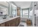 Bright bathroom boasts a dual sink vanity, soaking tub, and a glass enclosed shower at 1458 Longleaf St, Avon, IN 46123