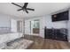 Stylish main bedroom features a television, hardwood floors, and ensuite bathroom access at 1458 Longleaf St, Avon, IN 46123