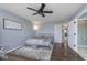 Bright main bedroom with hardwood floors, ceiling fan, and view into the bathroom at 1458 Longleaf St, Avon, IN 46123