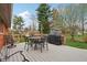 Outdoor deck featuring a wrought-iron table and chairs and a grill, perfect for entertaining guests outdoors at 1526 Chapman Dr, Greenfield, IN 46140