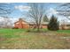 The home has a large backyard, perfect for gardening or Gathering fun, and a brick exterior at 1526 Chapman Dr, Greenfield, IN 46140