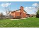 Backyard featuring a well-maintained lawn and mature trees, offering a private and peaceful outdoor space at 1526 Chapman Dr, Greenfield, IN 46140