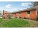 The home has a brick exterior with a lovely backyard and a cozy wooden deck at 1526 Chapman Dr, Greenfield, IN 46140