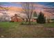 The home has a large backyard, perfect for gardening or Gathering fun, and a brick exterior at 1526 Chapman Dr, Greenfield, IN 46140