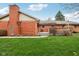Spacious backyard featuring a brick house and a well-maintained lawn, offering a serene outdoor space at 1526 Chapman Dr, Greenfield, IN 46140