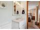 Cozy bathroom featuring a vanity with a marble countertop, soft lighting and view of a bedroom at 1526 Chapman Dr, Greenfield, IN 46140