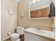 Cozy bathroom featuring a toilet, sink, and vanity with a mirrored medicine cabinet at 1526 Chapman Dr, Greenfield, IN 46140