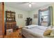 Comfortable bedroom with hardwood floors, a dresser, and a window letting in natural light at 1526 Chapman Dr, Greenfield, IN 46140