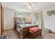 Bedroom with a wooden bed frame and bright windows, radiating a sense of warmth and relaxation at 1526 Chapman Dr, Greenfield, IN 46140