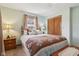Relaxing bedroom with a bed, dresser, and a large window providing ample natural light at 1526 Chapman Dr, Greenfield, IN 46140