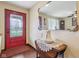 Traditional entryway features a decorative red door, ornate mirror, and wooden floors at 1526 Chapman Dr, Greenfield, IN 46140