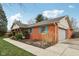 Home exterior with brick facade, attached garage, and manicured lawn at 1526 Chapman Dr, Greenfield, IN 46140