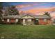 Charming single-story brick home features colorful shutters, landscaped yard, and inviting entrance at 1526 Chapman Dr, Greenfield, IN 46140