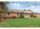 Single-story brick home features colorful shutters, landscaped yard, and covered entryway at 1526 Chapman Dr, Greenfield, IN 46140