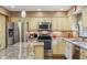 Bright kitchen with stainless steel appliances, granite countertops, and ample cabinet space at 1526 Chapman Dr, Greenfield, IN 46140