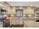 Well-lit kitchen with granite countertops, stainless steel appliances, and custom cabinetry at 1526 Chapman Dr, Greenfield, IN 46140