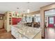 Spacious kitchen with an island that flows into the dining room, featuring granite countertops and ample storage at 1526 Chapman Dr, Greenfield, IN 46140