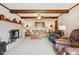 Cozy living room featuring a brick fireplace, wooden beams, and plush seating at 1526 Chapman Dr, Greenfield, IN 46140