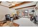 Spacious living room with wooden beams, sliding door to outdoor patio, and comfortable seating at 1526 Chapman Dr, Greenfield, IN 46140