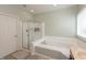 Well-lit bathroom featuring a glass-enclosed shower and a separate soaking tub with tile surround at 1559 Redsunset Dr, Brownsburg, IN 46112
