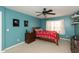Bright bedroom with blue walls, ceiling fan, and a comfortable bed, perfect for a relaxing space at 1559 Redsunset Dr, Brownsburg, IN 46112