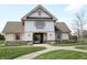 Elegant clubhouse exterior with stone accents, a welcoming entrance, and beautifully landscaped surroundings at 1559 Redsunset Dr, Brownsburg, IN 46112