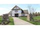 Elegant clubhouse exterior with stone accents, a welcoming entrance, and beautifully landscaped surroundings at 1559 Redsunset Dr, Brownsburg, IN 46112