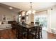 Open dining area with hardwood floors, modern lighting, a view of the living room, and access to the patio at 1559 Redsunset Dr, Brownsburg, IN 46112