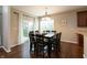 Dining area with a modern table set, chandelier, and a sliding glass door to the backyard at 1559 Redsunset Dr, Brownsburg, IN 46112