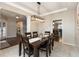 Dining area featuring modern lighting, dark wood furniture, and neutral-toned walls with carpet at 1559 Redsunset Dr, Brownsburg, IN 46112