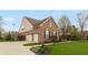Brick home featuring a three-car garage, nice landscaping, and a well-maintained lawn at 1559 Redsunset Dr, Brownsburg, IN 46112