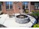 Cozy stone fire pit with chairs on a concrete patio, ideal for outdoor gatherings and relaxation at 1559 Redsunset Dr, Brownsburg, IN 46112
