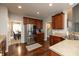 Well-equipped kitchen with stainless steel appliances, dark wood cabinets, and solid surface countertops at 1559 Redsunset Dr, Brownsburg, IN 46112
