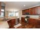 Functional kitchen with stainless steel appliances, dark wood cabinets, and hardwood floors at 1559 Redsunset Dr, Brownsburg, IN 46112