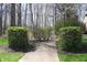 Professionally landscaped walkway with manicured hedges and lush greenery, adding to the home's curb appeal at 1559 Redsunset Dr, Brownsburg, IN 46112