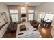 A spacious living room with high ceilings, ample windows, a fireplace, and a view into the dining area at 1559 Redsunset Dr, Brownsburg, IN 46112