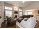 Spacious living room with vaulted ceiling, fireplace, and large windows providing ample natural light at 1559 Redsunset Dr, Brownsburg, IN 46112