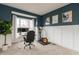 Home office space with built-in shelving, a comfortable chair, and a desk setup with dual monitors at 1559 Redsunset Dr, Brownsburg, IN 46112