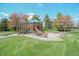 Community playground featuring a slide, climbing structure, and picnic tables on a grassy lawn at 1559 Redsunset Dr, Brownsburg, IN 46112