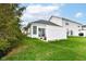 Backyard featuring a white fence, grassy area, and sliding glass doors at 16311 Sunland Ct, Westfield, IN 46074