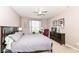Well-lit bedroom with large bed, ceiling fan, tasteful decor, and a cozy reading nook at 16311 Sunland Ct, Westfield, IN 46074