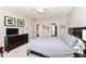 Bedroom with gray bedding, dresser, ceiling fan, and access to the bathroom and walk-in closet at 16311 Sunland Ct, Westfield, IN 46074