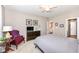 Comfortable bedroom featuring a ceiling fan, soft carpet, and a cozy sitting area with a decorative red chair at 16311 Sunland Ct, Westfield, IN 46074