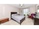 Cozy bedroom featuring neutral tones, a ceiling fan, a decorative window, and a comfortable queen-sized bed at 16311 Sunland Ct, Westfield, IN 46074