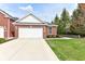 Charming brick home featuring a well-manicured lawn and attached two-car garage at 16311 Sunland Ct, Westfield, IN 46074