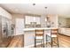 Modern kitchen featuring a breakfast bar, stainless steel appliances, and white cabinetry at 16311 Sunland Ct, Westfield, IN 46074