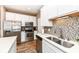 Bright, open kitchen featuring white cabinets, stainless steel appliances, subway tile backsplash, and light wood flooring at 16311 Sunland Ct, Westfield, IN 46074
