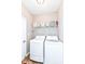 Well-lit laundry room featuring a washer, dryer, and storage shelf at 16311 Sunland Ct, Westfield, IN 46074