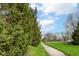 Scenic walkway lined with lush greenery under a bright, partly cloudy sky at 16311 Sunland Ct, Westfield, IN 46074